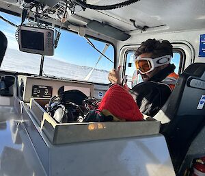 Person driving a machine across the  ice, looking confused