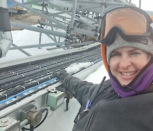 Female tradie's selfie with site services tray of electrical cables