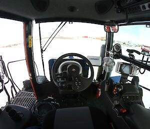 Wide-angle view of a tractor cab from the driver's seat