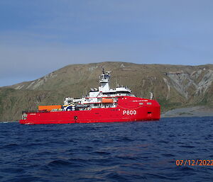 French icebreaker L'Astrolabe at Macquarie Island with the cliffs behind it