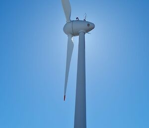 A wind turbine with the sun behind