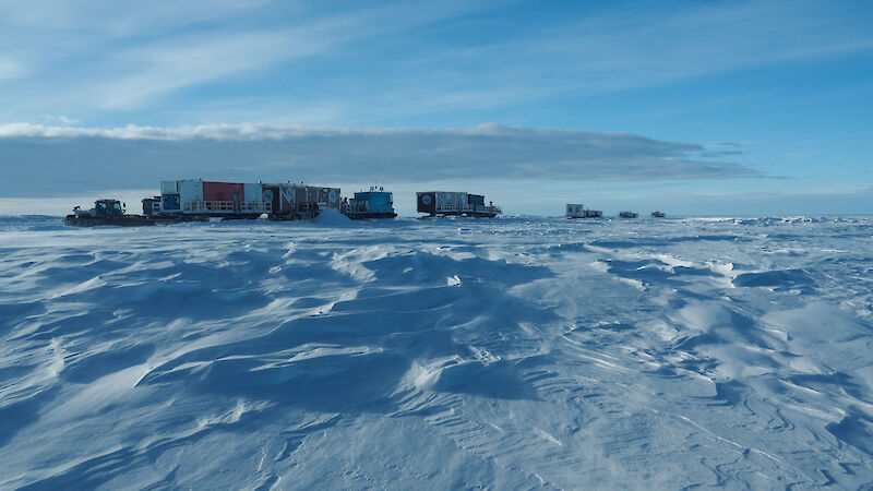 Traverse train in the middle ground with snow in the foreground