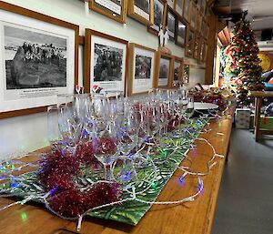 Christmas decorations on a table under a wall of photos