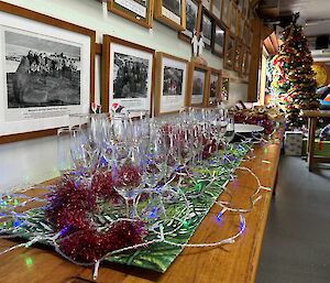 Christmas decorations on a table under a wall of photos