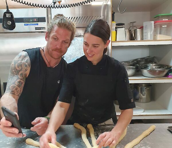 Two cooks braiding Challa dough