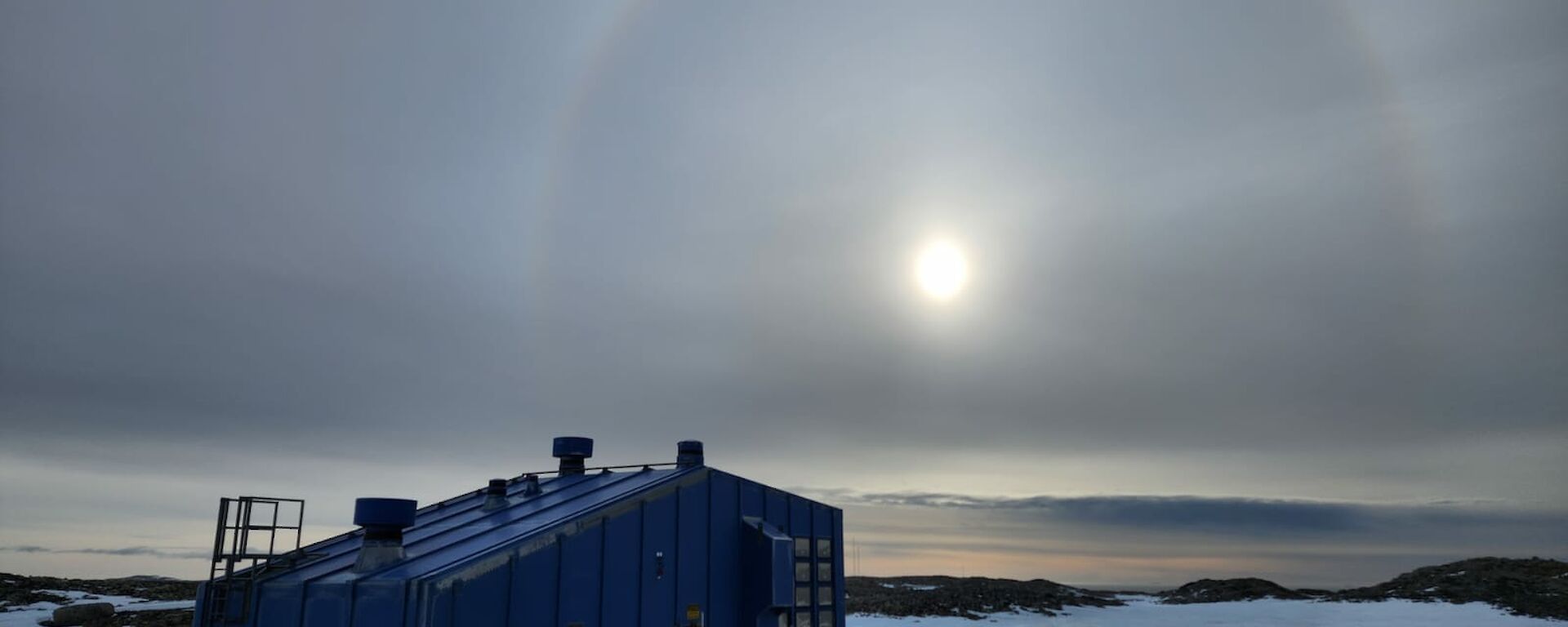 Cirrostratus cloud and halo over Casey's blue Balloon Shed