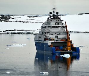 Refuelling the blue and water vessel the "Aiviq" parked in the bay at Casey