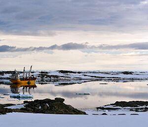 Resupply vessel the "Happy Diamond" parked in the bay at against a backdrop of snow and ice