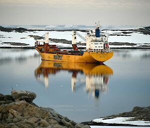 Resupply vessel the "Happy Diamond" parked in the bay at Casey on mirror-like waters