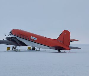 Red Basler aircraft parked on snow