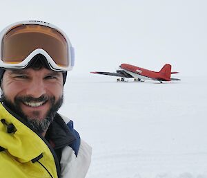 Expeditioner selfie in front of red Basler aircraft