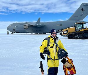 Expeditioner standing in front of C-17 Globemaster and refuelling tractor