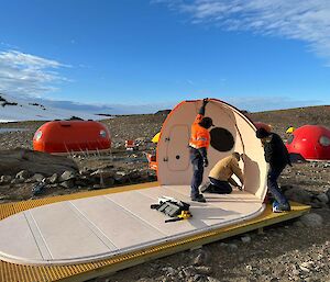 A partially built melon tent on a rocky slope