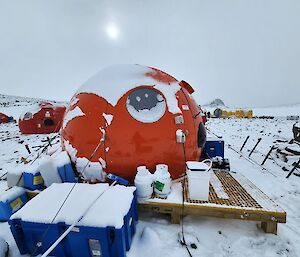 Orange melon hut covered in snow