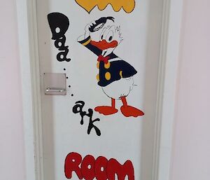 A cartoon duck is painted on a white door
