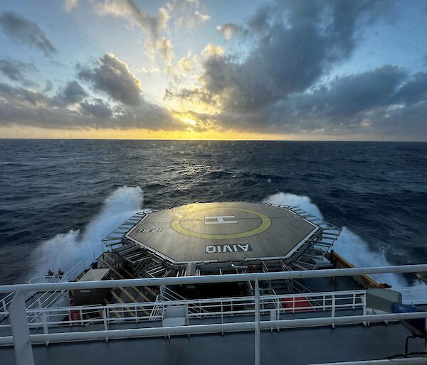 The front of a ship creates spray as it goes through the waves