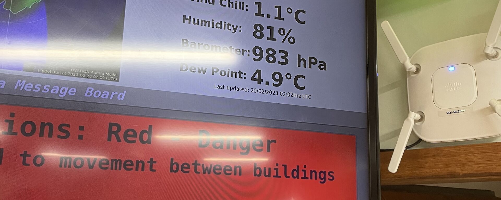 An electronic sign on a wall displays the current weather conditions