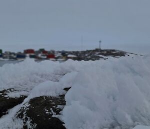 Ice formed on rocks with station in the background