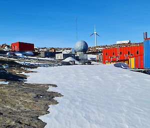 Brightly coloured buildings are spread across a rocky terrain