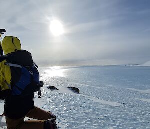 Two men look out over a frozen lake