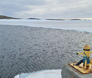 Ice is beginning to cover the water of a harbour