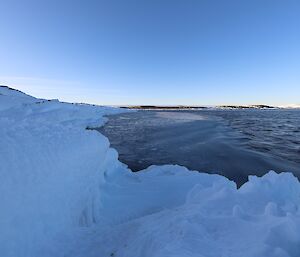 Sea water is beginning to freeze against an icy shore