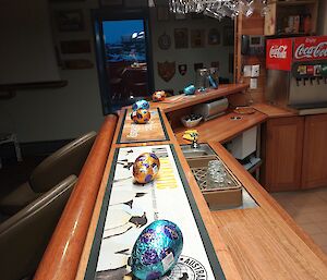 Easter eggs are lined up on a bar top