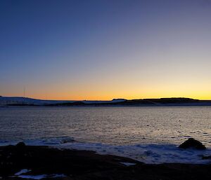 The sun sets on a frozen landscape