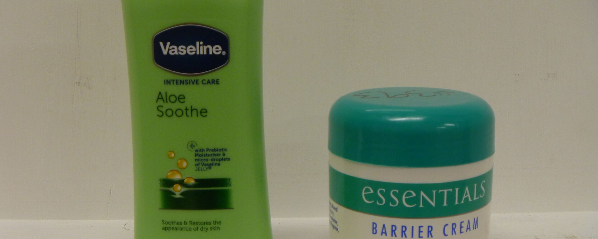 A container of moisturising cream and a tub of barrier cream