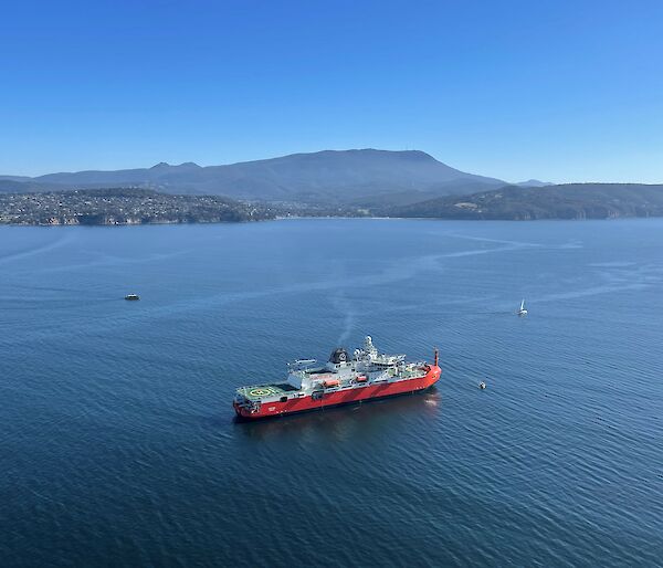 A large icebreaker arrives in Hobart in calm seas and clear skies