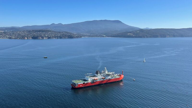 A large icebreaker arrives in Hobart in calm seas and clear skies