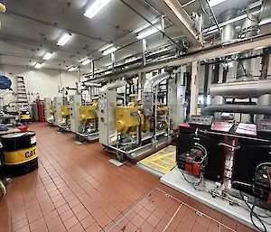 Four large power generators inside a large room