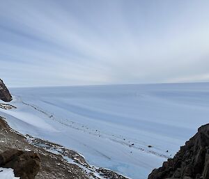 Clouds stretch across the sky over an ice plateau