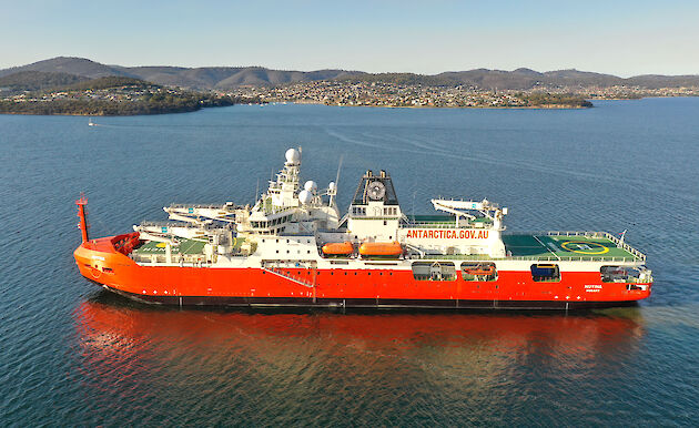 An aerial view of a large icebreaker, RSV Nuyina on Hobart's River Derwent