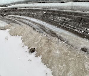 Layers are seen in the ice and rock formation carved by the wind