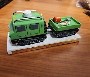 A matchboxed size pale green Hagglund carved from wood.