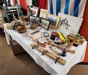 A range of mostly handcraft gifts are spread across a table.