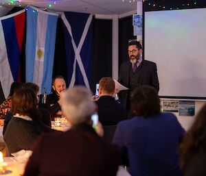 A distinguished looking gentleman with dark hair and a grey beard makes a speech to a raptured crowd (ok, I wrote this caption!)
