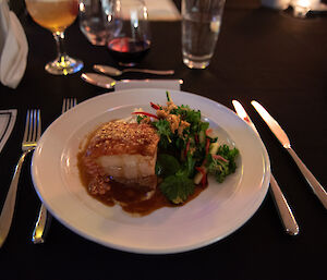 A white plate wth slow cooked pork belly, parsnip puree, apple remoulade, shallot and balsamic pearls