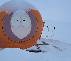 An orange, former radar dome, about 2.5 m in diameter, now painted to resemble Kenny from South Park.