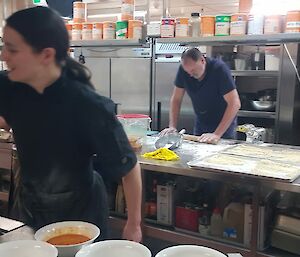 The author in action in the kitchen over hot pots with the ramen production line in the background.