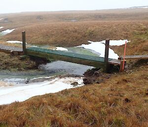 New wooden bridge over a snowy area