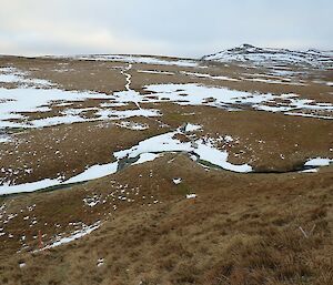 Landscape vista with patches of snow