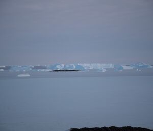 Icebergs set into the frozen sea.