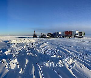 The traverse cargo laydown area (Goat yard) with the camp in the foreground. Snow groomers are used to level the area and remove the excess snow that had built up.