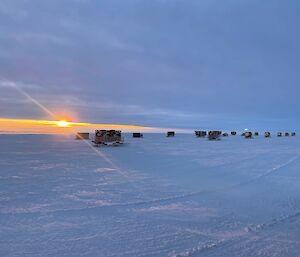 A sunset in the distance behind the traverse fleet