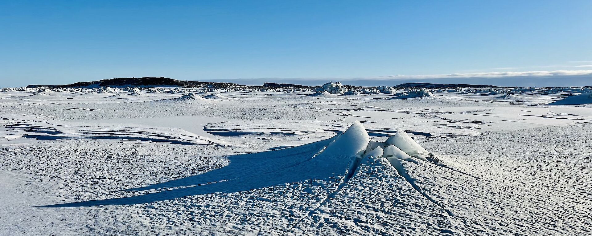 Sea-ice with a volcano-like tide crack in the centre.