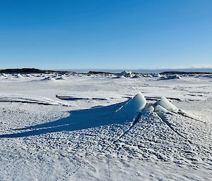 Sea-ice with a volcano-like tide crack in the centre.