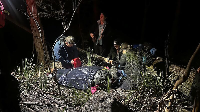 A group work on building a shelter in the dark