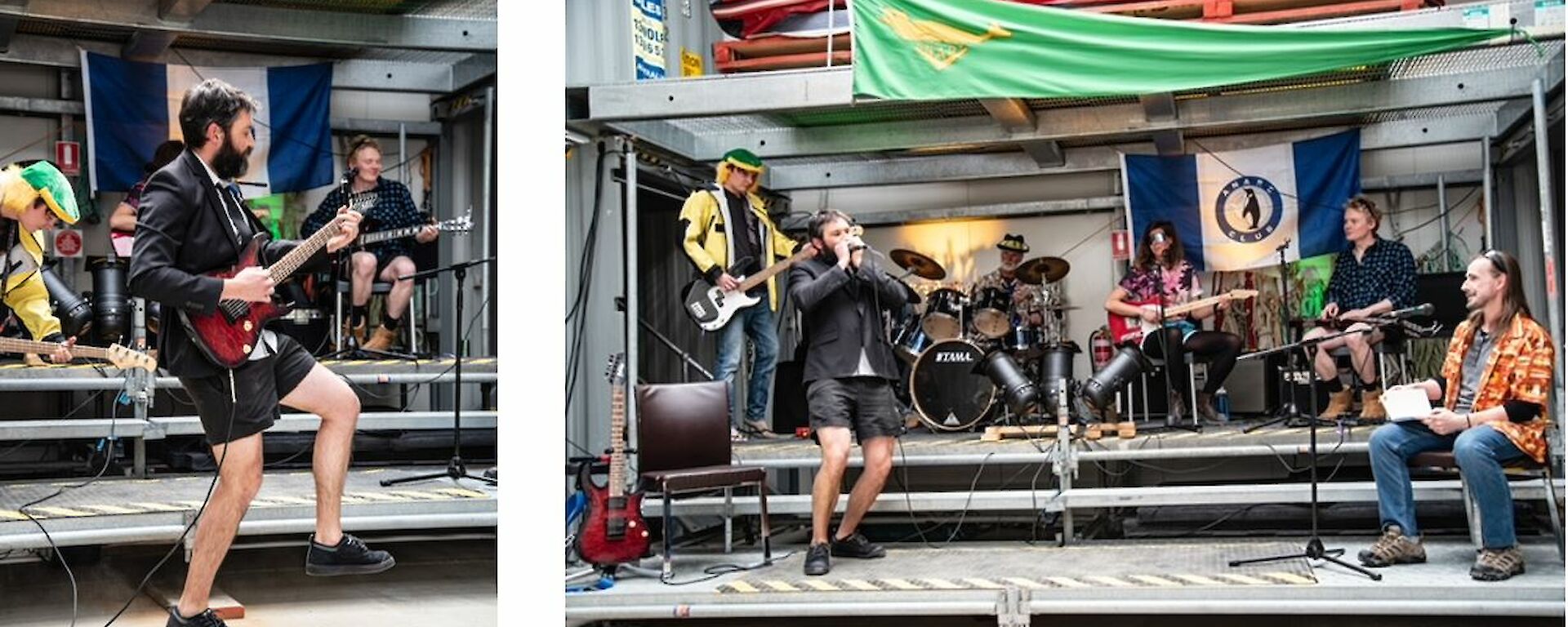A bearded man plays a bass guitar as part of a band that is playing on a multi-level stage.